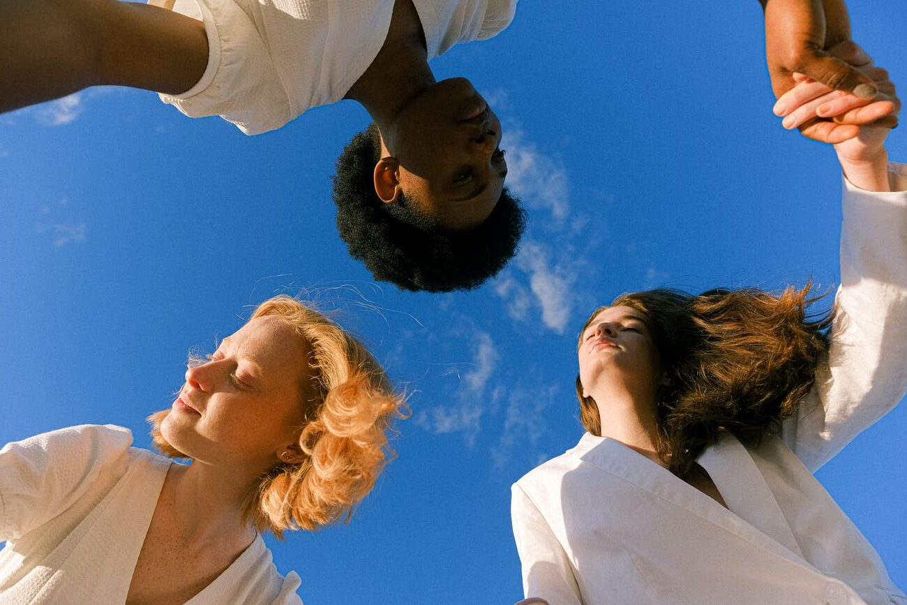 photo of women holding each other s hands